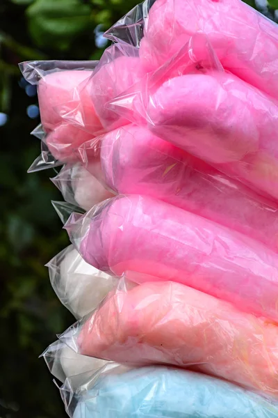 Bags with cotton candy of various colors during an afternoon in the park