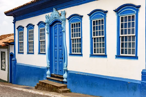 Facade of old house in colonial style in blue and white colors in the city of Sabara, Minas Gerais