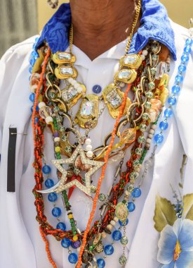 Necklace used by man during traditional religious celebration in Brazil with common symbols the practice of umbanda and candomble clipart