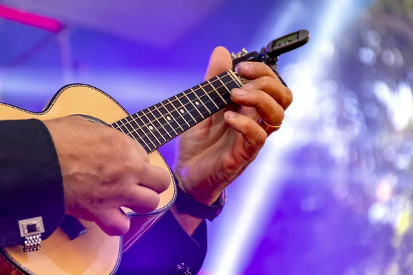 Live musical performance of Brazilian popular music called chorinho with little acoustic guitar with four strings