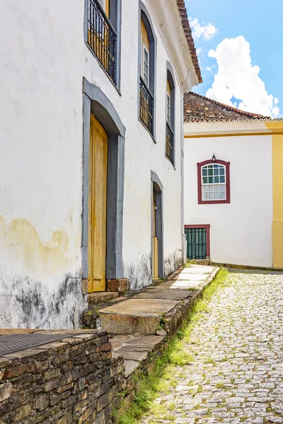 Facade of old houses built in colonial architecture with their balconies, roofs and colorful details in the historical city of Ouro Preto in Minas Gerais.