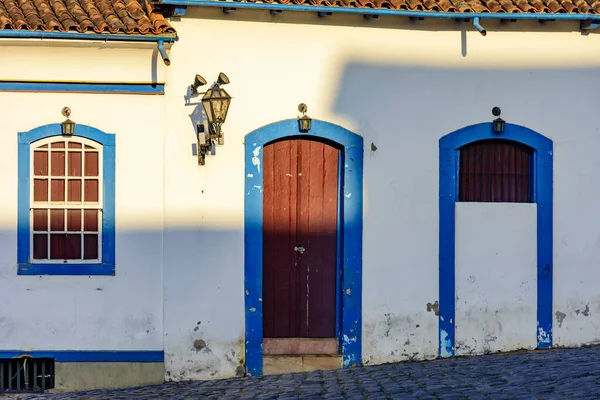 Facade of old house in colonial architecture in the city of Ouro Preto, Minas Gerais with blue windows and door