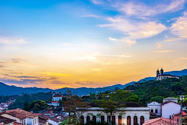 View of old houses and churches in colonial architecture from the 18th century at sunset in the historic city of Ouro Preto in Minas Gerais, Brazil