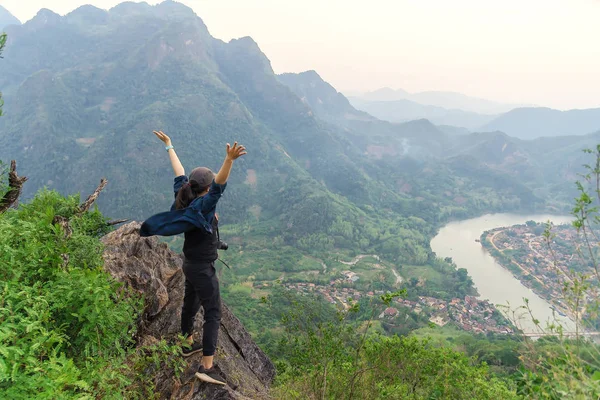 Woman hiker relaxing on a top of a mountain admiring surrounding — Stock Photo, Image