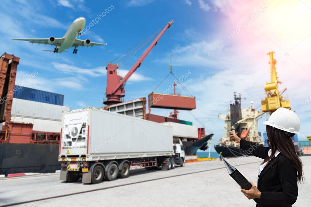 The women engineer working with container Cargo freight ship in 