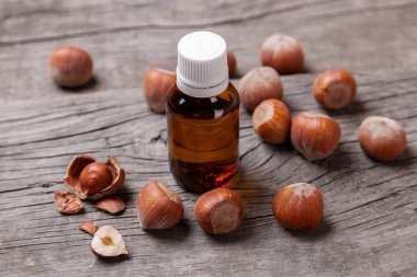 Fındık, besleyici elemanları yağdan. Şişe yağı ve fındık eski ahşap masa.