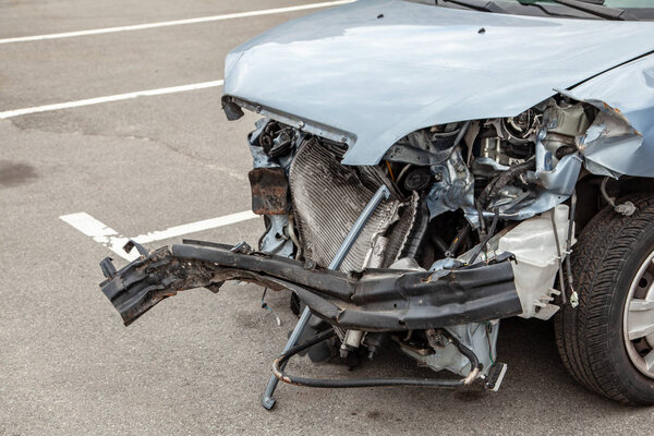 The car is broken in front, the hood, the radiator, the headlights, the bumper, the engine