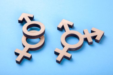 Symbol of transgender and gender symbols of man and woman of tree on blue clipart
