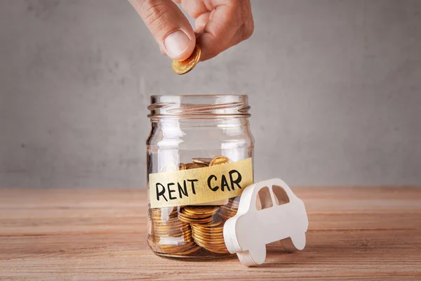 Rent car. Glass jar with coins and an inscription of rent car and symbol of car