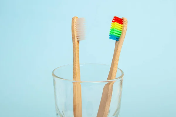 Conjunto de escovas de dentes em vidro sobre fundo azul. Seleção de escova de dentes conceito, bambu eco-friendly. Conceito de minorias sexuais e comunidade LGBT — Fotografia de Stock