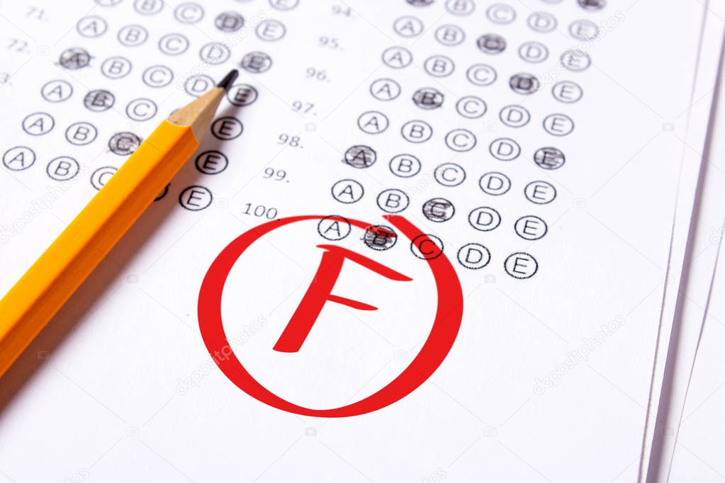 Bad grade F is written with red pen on the tests
