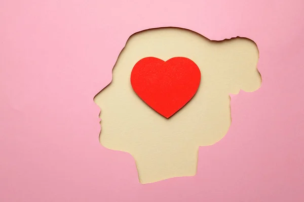 Silhouette of woman and inside the brain in the head heart as symbol of love.