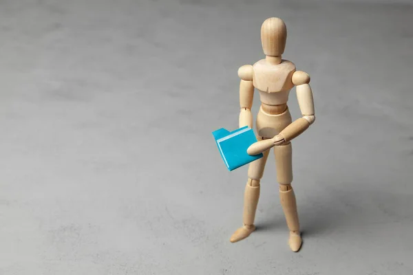 Security of personal information. Wooden man holding blue folder with files. — Stock Photo, Image