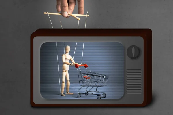 Fake News on TV. Control over the behavior of the buyer. Man with  shopping trolley from the supermarket like doll  by puppeteer.