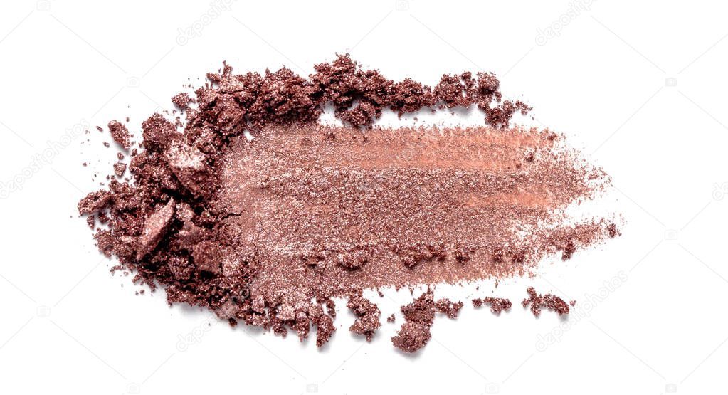 Eye shadow on a white background. Scattered blush sample for makeup. Brown color.