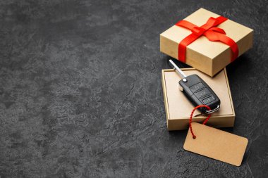 Hediye kutusu ile uzaktan kumanda alarm sistemi etiket ve kırmızı kurdele yayla ile araba anahtarları. Kopya alanı