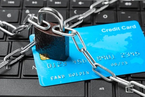 Carta di credito in catena con serratura su tastiera portatile. Divieto di pagamenti e acquisti online nel negozio online — Foto Stock