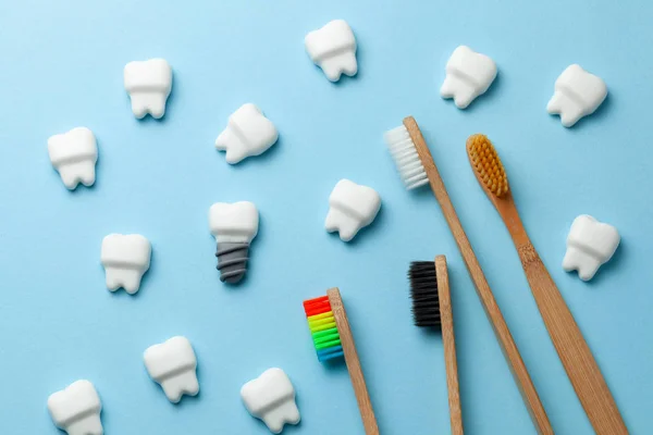 Dentes brancos saudáveis e implantes em fundo azul com escova de dentes — Fotografia de Stock