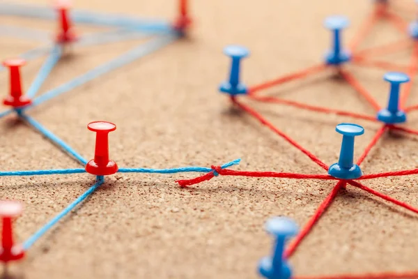 Business team. Connect between business people. Contract Arrangements. Office pins connected by blue and red thread and contract between the teams