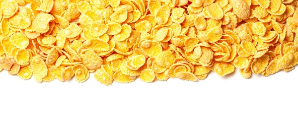 Cornflakes dry breakfast. Yellow flakes in bunch on top of frame isolated on white background — Stock Photo, Image