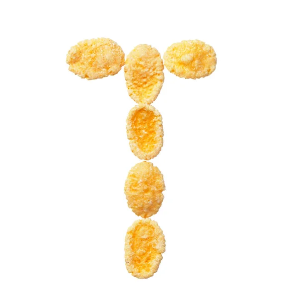 Cornflakes amarelo letra T isolado sobre fundo branco. Flocos de cereais alfabetos . — Fotografia de Stock