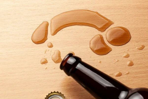 Impotence from alcohol. Beer bottle and beer spilled in the shape of penis — Stockfoto