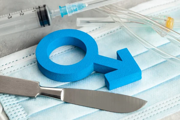 Sex-change operation. Change of male to female. Symbol of a man and a scalpel with a syringe. Surgical Instruments — Stock Photo, Image