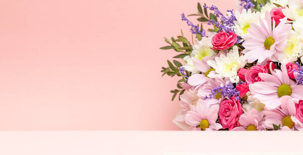 Bouquet of flowers on a pink background