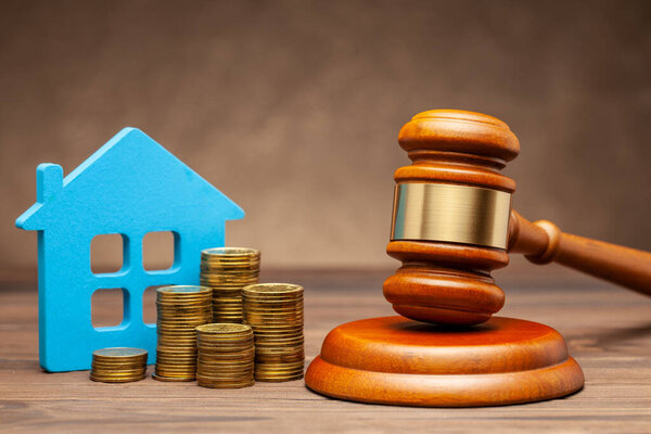 Divorce by law. Division of property after a divorce. House with money and a judge gavel