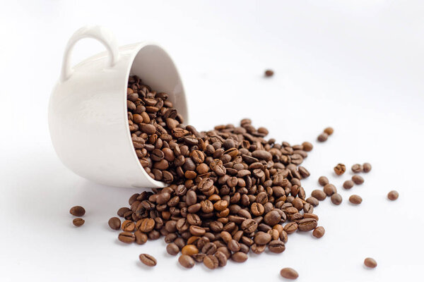 Coffee beans in white cup isolated on white background, drinks concept