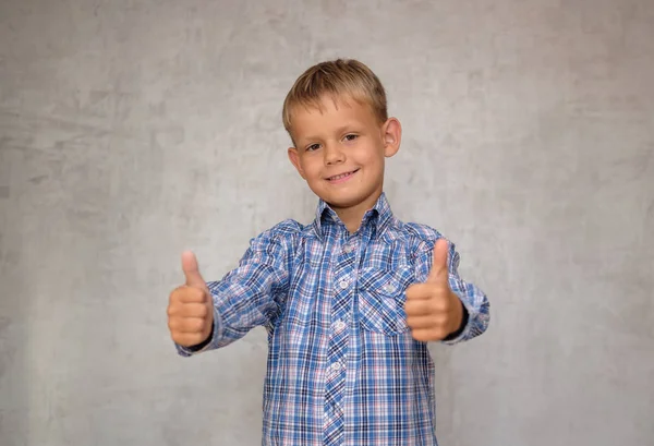 Happy European Boy Shows Gesture Both Hands Grey Wall Background — Stock Photo, Image