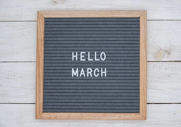 English text Hello March on a letter Board in white letters on a gray background — Stock Photo, Image