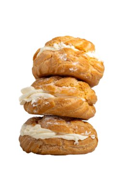 a stack of freshly baked choux pastries or cream puffs, isolated on white background