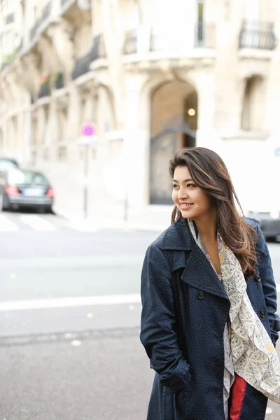 Asian female student going in street background, walking after classes.