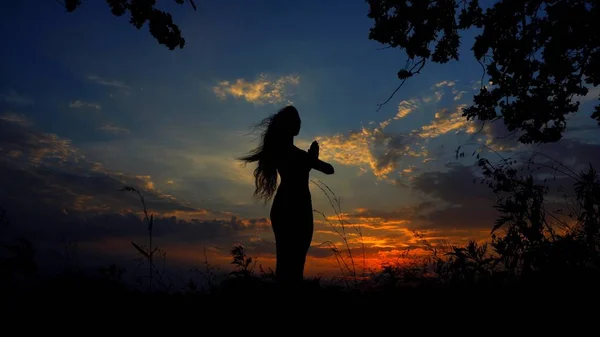 Sombra negra silueta femenina rezando en el fondo del cielo de la noche . — Foto de Stock