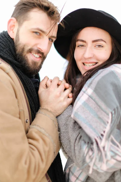 Porträt eines Paares mit Schal und Hut vor weißem Hintergrund. — Stockfoto