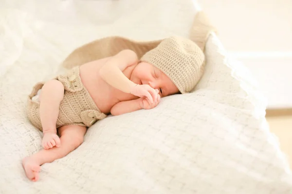Neugeborenes schläft und trägt gehäkelte Kleidung. — Stockfoto