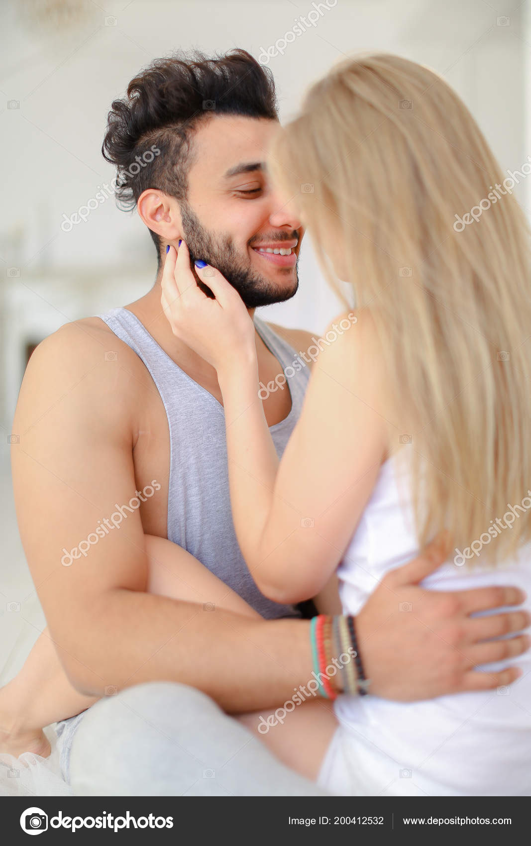 Hispanic Man With Beard Hugging Blonde Caucasian Woman Wearing