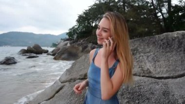 Ağır çekim avukat erkek deniz kenarında yürüyüş Smartphone cep telefonu ile konuşmak