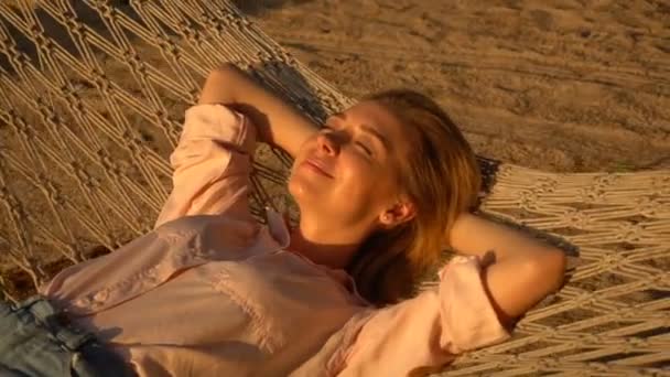 Slow motion model female relaxing on hammock during break — Stock Video