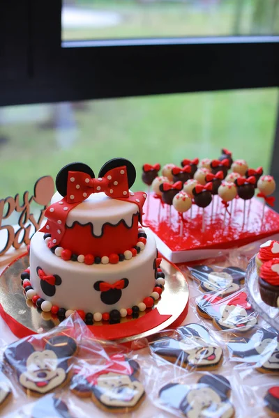 Red Mickey Mouse cake for birthday celebration.