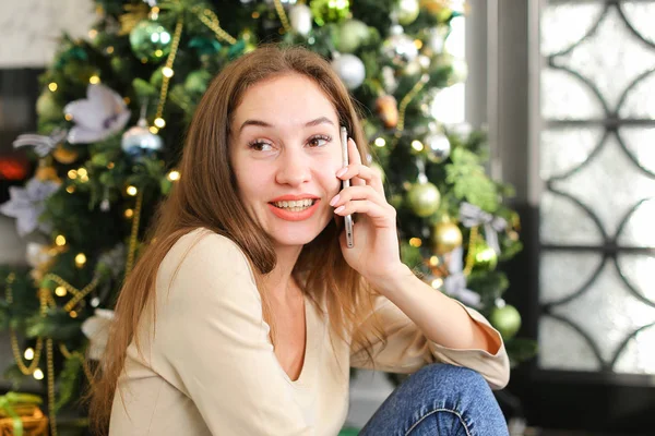 painter girl using smartphone to wish happy New Year to friends.