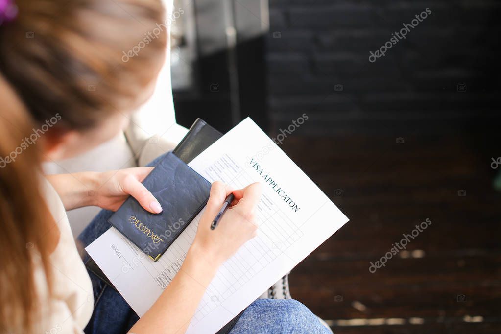 student female preparing documents for getting visa to study abr
