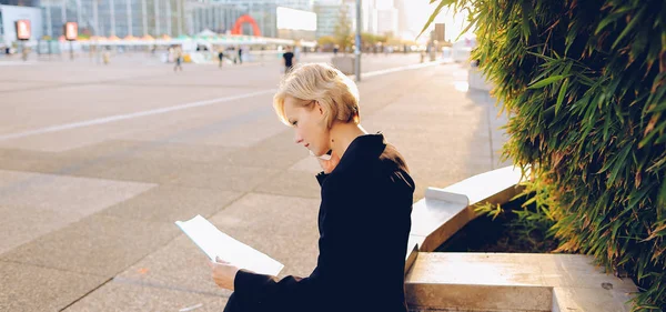 Businesswoman speaking by smartphone outside with document case. — Stock Photo, Image