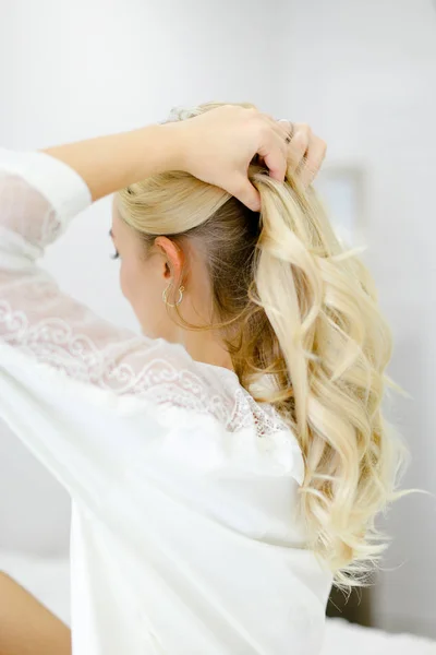 Young blonde caucasian girl wearing white closes touching curly hair. — Stock Photo, Image