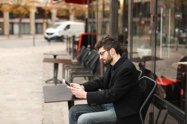 Online poker oyuncusu kafeterya masada tablet kullanma  .