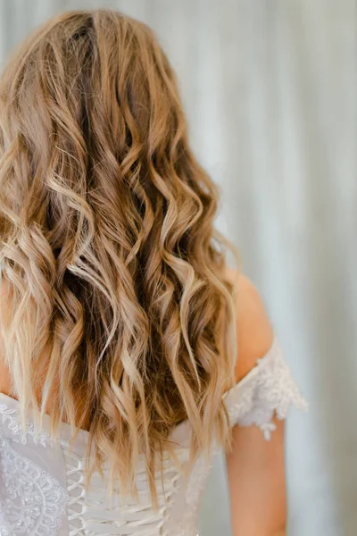 Back view of bride with long blonde curly hair at photo studio. — Stock Photo, Image