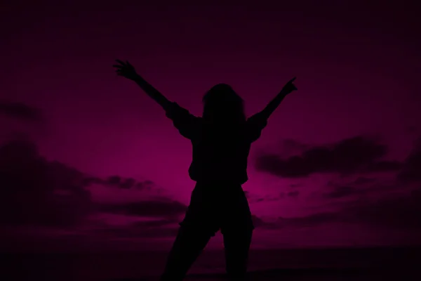 Female silhouette with raised hands on violet sunset sky background in Thailand. — Stock Photo, Image