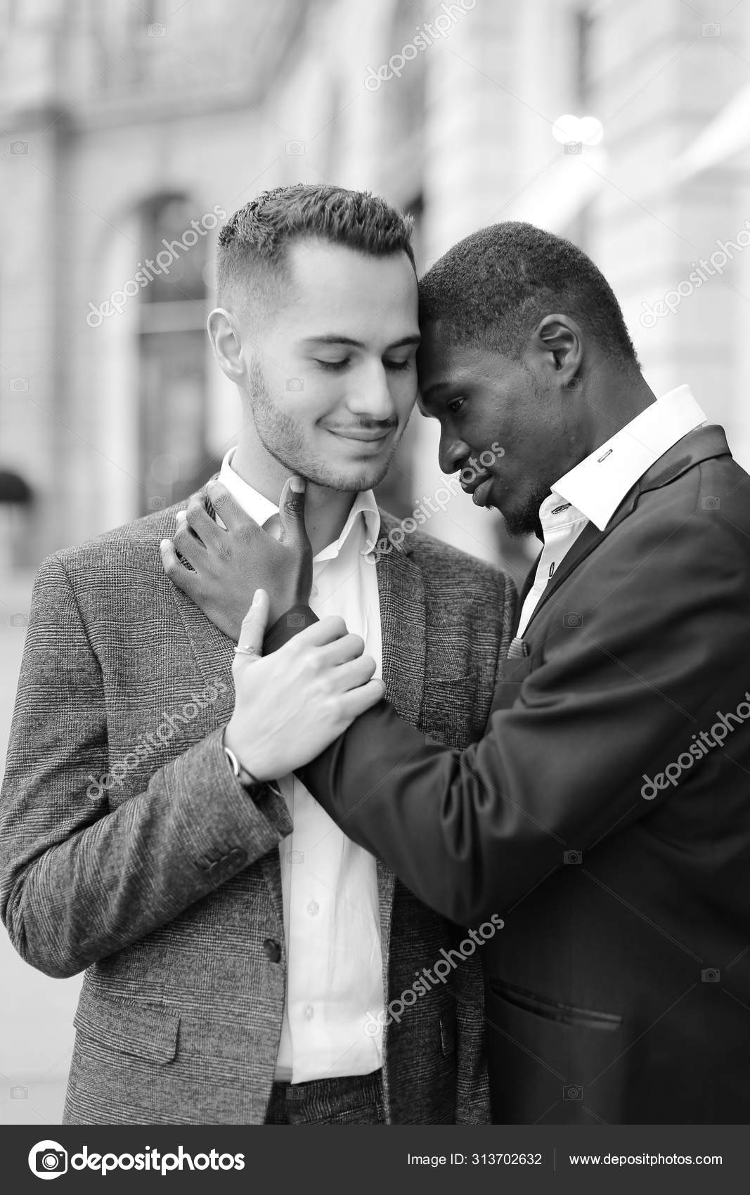 Black and white photo of afro american gay hugging caucasian