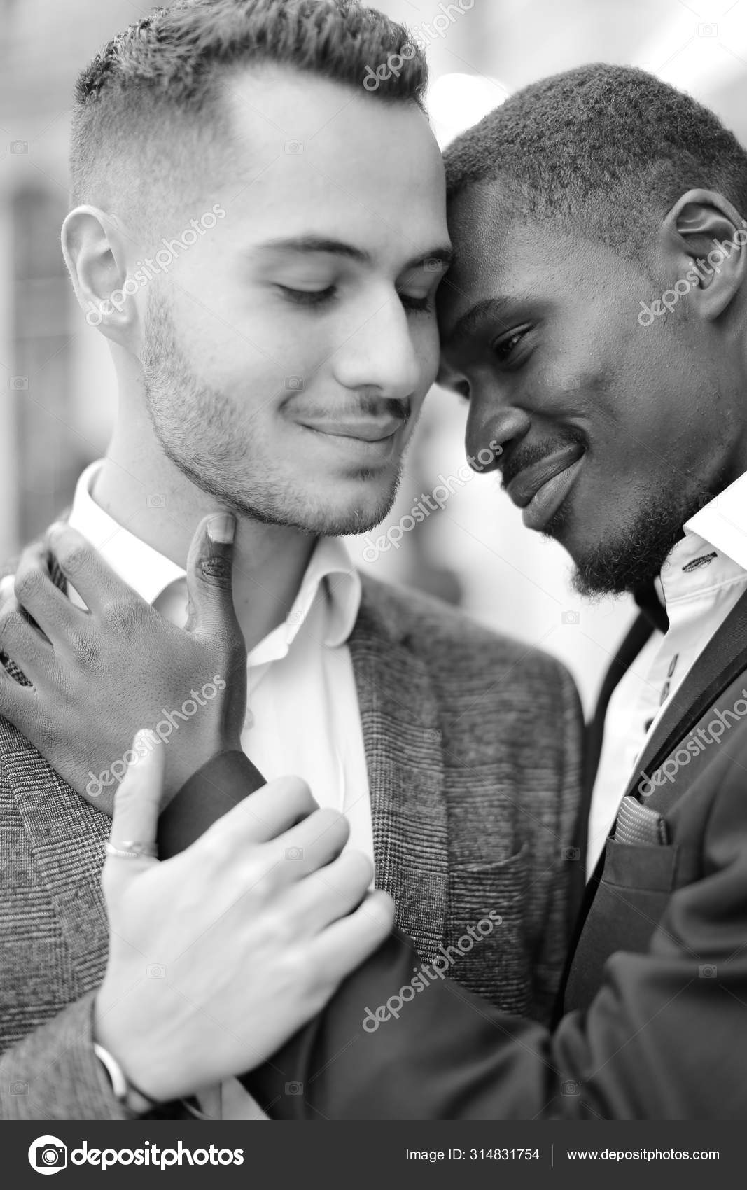 Black and white portrait of afro american gay hugging caucasian